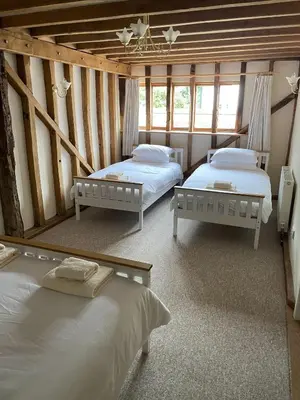 a room with two beds in a room with windows at Kings Barn - English Countryside Retreat in Lindsell