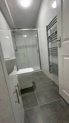 a bathroom with a shower and a toilet at Diamond House in Friern Barnet