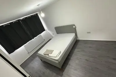 a small bed in a room with at Diamond House in Friern Barnet