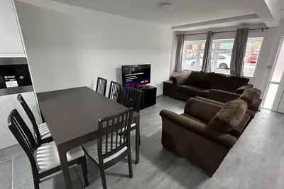 a living room with a table and a couch at Diamond House in Friern Barnet