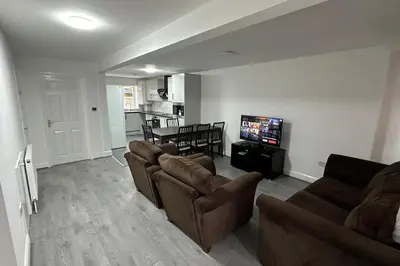 a living room with couches and a flat screen tv at Diamond House in Friern Barnet
