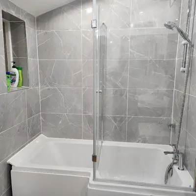 a bathroom with a shower and a white tub at Great Central self-contained flat in Cambridge