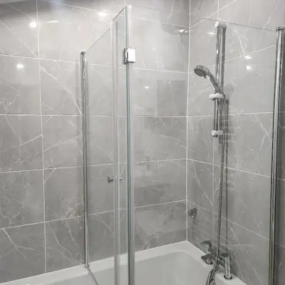 a bathroom with a shower and a bath tub at Great Central self-contained flat in Cambridge