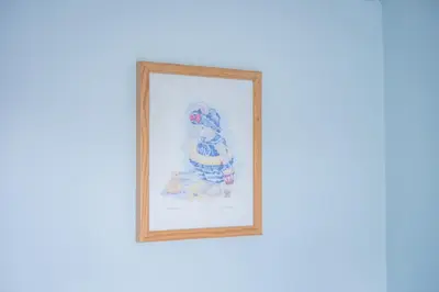 a framed picture of a snowman on a wall at Charming Family-Friendly 3-Bedroom House with Parking & Spacious Garden in Milton