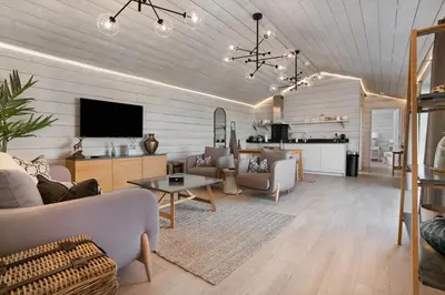 a living room with a couch and a table at Orchard Cottage in Saint Osyth