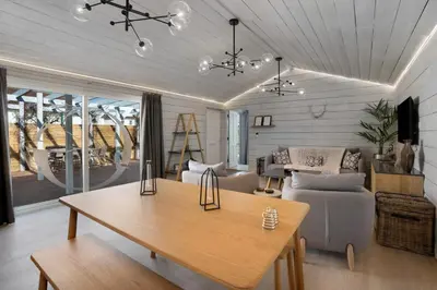 a living room with a table and a couch at Orchard Cottage in Saint Osyth