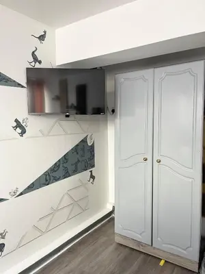 a room with a closet and a staircase with birds on the wall at Penn Gardens 2 beds Apartment-2 in Friern Barnet
