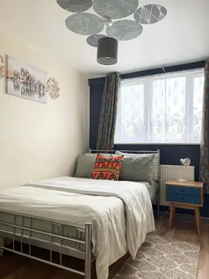 a bedroom with a bed and a ceiling at Penn Gardens Spacious 2 Beds - 1 in Friern Barnet