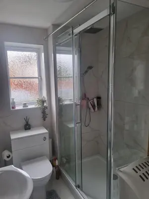 a bathroom with a shower and a toilet and a sink at The Pringle Inn in Great Baddow