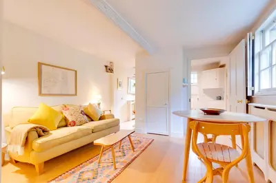 a living room with a couch and a table at Pass the Keys Charming Cottage in City Centre with Free parking in Cambridge