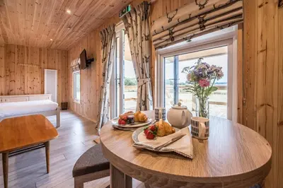 a wooden room with a table with food on it at River Retreat, Aldeburgh in Aldeburgh