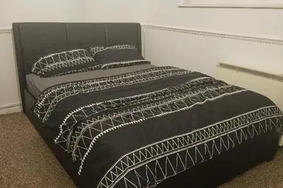 a black bed with a black and white blanket at 1 Bed House Sleeps 2 -Free Parking -Tv in Romford