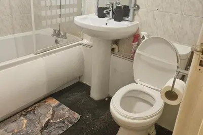 a bathroom with a toilet and a sink at 1 Bed House Sleeps 2 -Free Parking -Tv in Romford