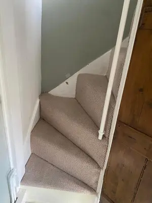 a set of stairs in a room with a door at Sun lane cottage in Woodbridge
