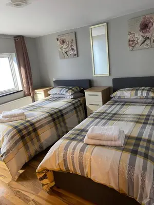 two beds sitting next to each other in a bedroom at The Shak in Banham