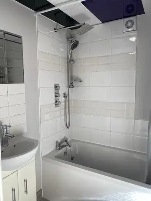 a bathroom with a bath tub and a sink at The Shak in Banham