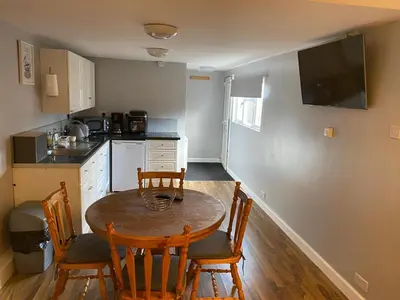 a kitchen with a table and chairs in a room at The Shak in Banham