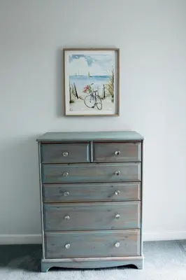 a painting above a dresser with a bike on it at Lovely 3 Bedroom House in Chelmsford in Chelmsford