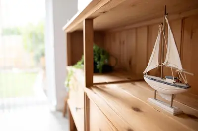 a model boat on a shelf in a room at Lovely 3 Bedroom House in Chelmsford in Chelmsford