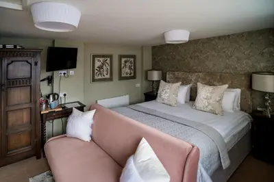 a bedroom with a large bed and a couch at Brewers Inn in Cambridge