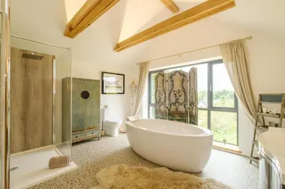 a large bathroom with a large tub and a shower at Sandown in Snape