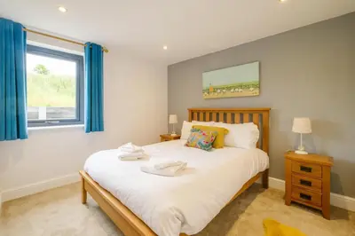 a bedroom with a bed and a window at Sandown in Snape