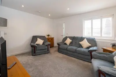 a living room with two chairs and a couch at 1 Buxlow Cottages in Aldringham