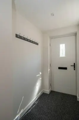 an empty room with a door and a window at 1 Buxlow Cottages in Aldringham