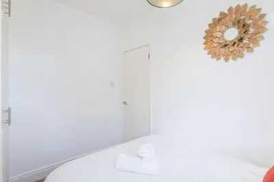 a bathroom with a toilet and a mirror at Stylish 2-Bedroom House in the Heart of Cambridge in Cambridge