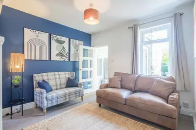 a living room with a couch and a chair at Stylish 2-Bedroom House in the Heart of Cambridge in Cambridge
