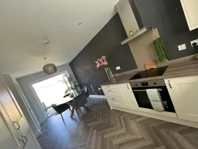 a kitchen with a counter and a table with a window at Cosy room in Great Bromley