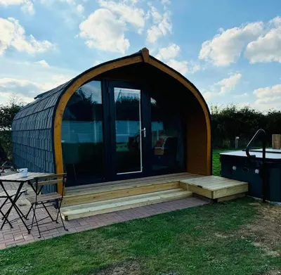 a large gazebo with a table and a grill at Windmill Glamping Pod with hot tub - The Snug in Swavesey