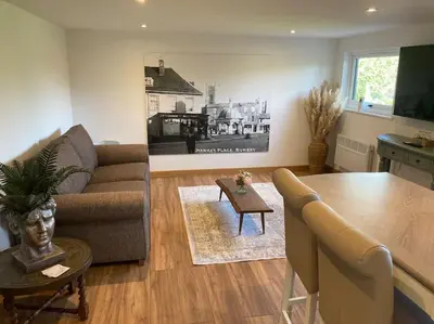 a living room with a couch and a table at Wood Lodge in Bungay