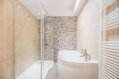 a bathroom with a shower and a toilet and a sink at The Red House, Leiston in Woodbridge