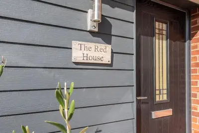 a sign that reads the rest house next to a door at The Red House, Leiston in Woodbridge