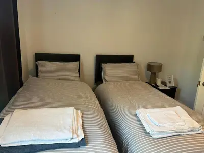 two beds sitting next to each other in a bedroom at Ivy on Sea Villa in Southend-on-Sea