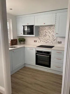 a kitchen with white cabinets and a stove top oven at Modern Luxe Maisonette Near Station With Free Parking in Billericay