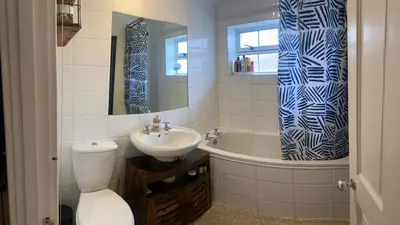 a bathroom with a toilet and a sink and a tub at relaxed and peaceful #2 in St Ives