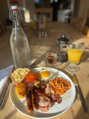 a plate of breakfast food with an egg and beans at relaxed and peaceful #2 in St Ives