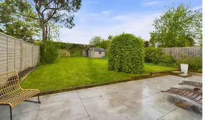 a backyard with a fence and a grass yard at relaxed and peaceful #2 in St Ives