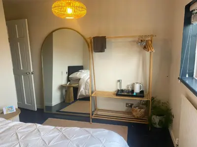 a bedroom with a bed and a room with a mirror at relaxed and peaceful #2 in St Ives