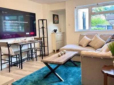 a living room with a couch and a tv at Bibis Home - Hertford in Hertford
