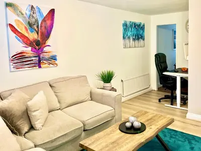 a living room with a couch and a table at Bibis Home - Hertford in Hertford