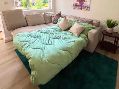 a large bed sitting on top of a couch at Bibis Home - Hertford in Hertford