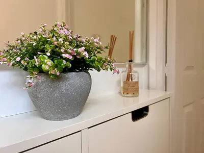 a vase filled with flowers sitting on top of a counter at Bibis Home - Hertford in Hertford