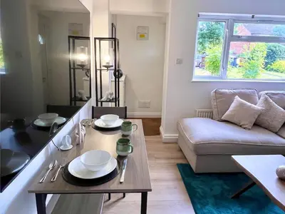 a living room with a table and a couch at Bibis Home - Hertford in Hertford