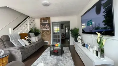 a living room with a couch and a tv at Single Room Near Basildon City Centre in Basildon
