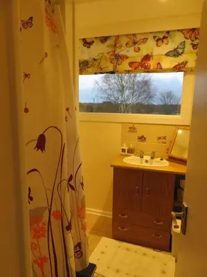 a bathroom with a sink and a window at Tresco - Aldeburgh's hidden gem in Aldeburgh
