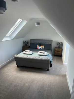 a bedroom with a bed in a attic at The Snug at Fourleys in Woodhurst