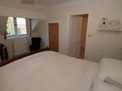 a bedroom with a white bed and a window at Top Deck at The Cabin in Fornham Saint Martin